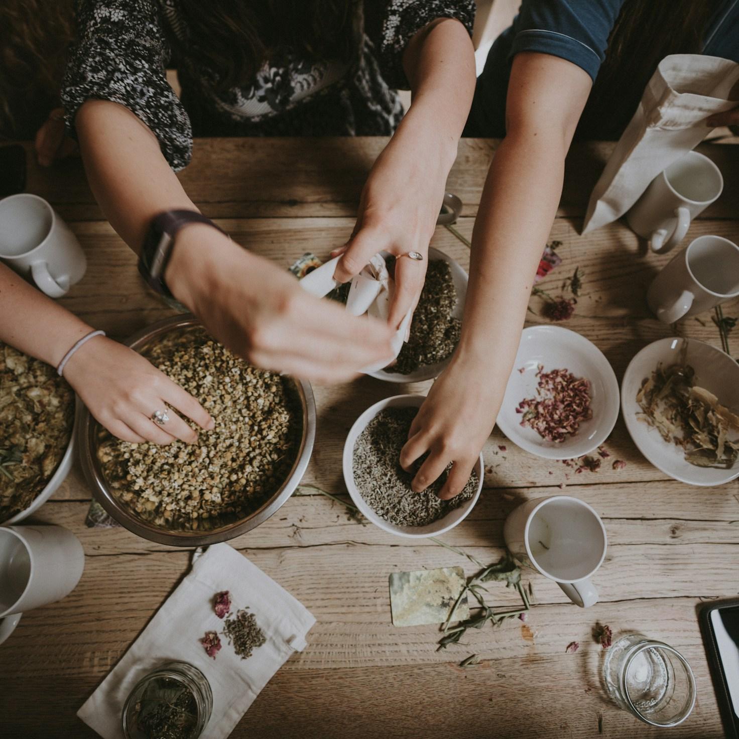 Community members cooking together in a modern kitchen, sharing recipes and techniques
